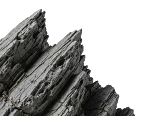 A rugged, dark gray rock formation with sharp jagged edges and intricate textures, isolated on a transparent background with copy space, professional studio shot for natural strength concept