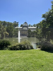 The Crystal Palace amidst greenery on a sunny day, Retiro Park, Madrid, Spain