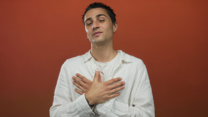 Young hispanic man gestures on an isolated red background wearing a white shirt and expressing...