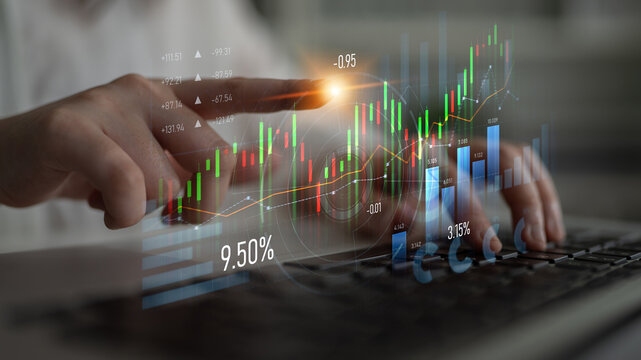 A business professional uses a laptop to analyze financial growth trends with touchpoints on a digital interface showcasing graphs and statistics in a modern workspace. Scalp