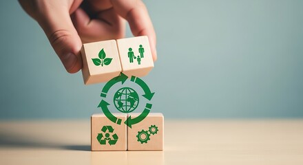 Hand stacking wooden blocks with symbols of sustainability, recycling, and family, representing ecofriendly living and future