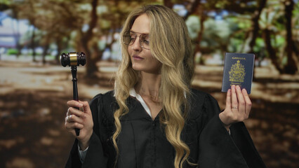 Blonde woman in judge uniform holds canadian passport and gavel in a green park setting, signifying...