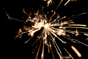 Fototapeta premium Bright Sparklers Burning on Pure Black Background