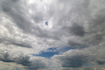 A dramatic and enchanting sky with stunning blue patches among fluffy clouds above