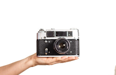 retro camera in female hand on light background as background