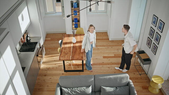 Married couple moving together top view. Loving husband covering wife eyes