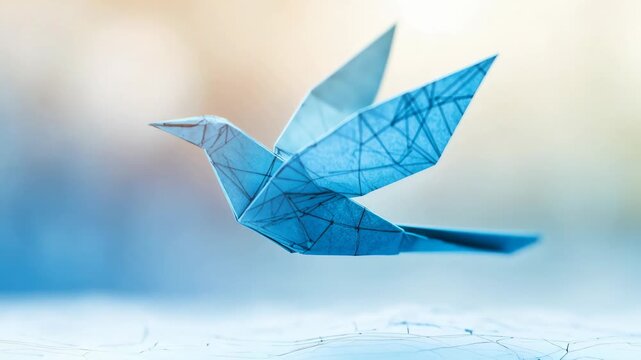 A delicate blue origami bird taking flight symbolizes creativity and imagination in art and craft.