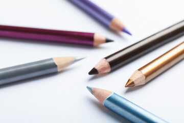 Colorful eye pencils on white background, closeup