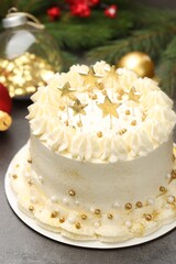Delicious cake with Christmas decor on grey table, closeup