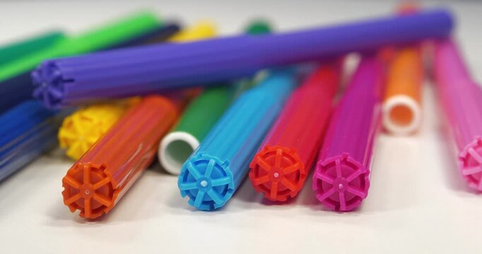 Varicolored felt-tip pens on white table