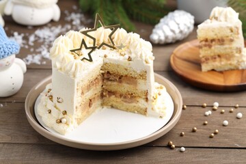 Delicious cake with Christmas decor on wooden table, closeup
