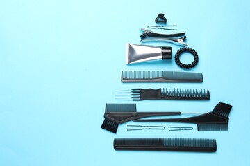 Christmas tree made of hairdresser's tools on light blue background, above view. Space for text