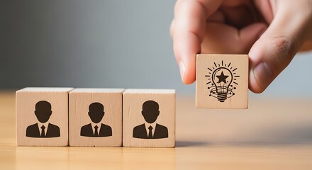 Hand selecting a wooden block with a lightbulb idea symbol