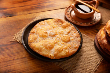Mexican Buñuelos. Traditional food at Christmas and winter holidays in Mexico, these are fried dough flatbread sprinkled with sugar or covered in a syrup made with piloncillo, cinnamon, and guava.