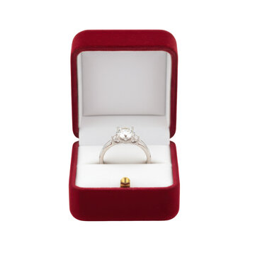Elegant engagement ring with glittering diamonds displayed in a luxurious velvet box, offering love