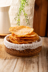 Mexican Buñuelos. Traditional food at Christmas and winter holidays in Mexico, these are fried dough flatbread sprinkled with sugar or covered in a syrup made with piloncillo, cinnamon, and guava.