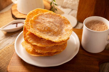Mexican Buñuelos. Traditional food at Christmas and winter holidays in Mexico, these are fried dough flatbread sprinkled with sugar or covered in a syrup made with piloncillo, cinnamon, and guava.