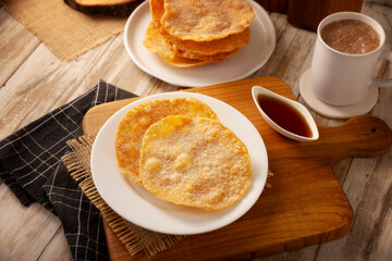 Mexican Buñuelos. Traditional food at Christmas and winter holidays in Mexico, these are fried dough flatbread sprinkled with sugar or covered in a syrup made with piloncillo, cinnamon, and guava.