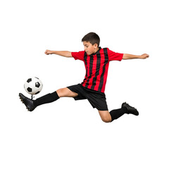 Young boy in red and black jersey kicking soccer ball in mid air