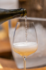 Pouring sparkling wine into wine glass