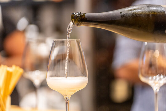 Pouring sparkling white wine into a glass