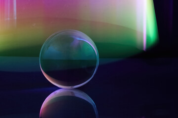 Enigmatic Sphere. A glass sphere reflects vibrant gradients of light, creating a surreal and...
