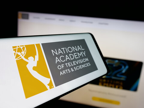 Stuttgart, Germany - 10-31-2025: Smartphone with logo of US television award Emmy Awards (Emmys) on screen in front of website. Focus on center-left of phone display.
