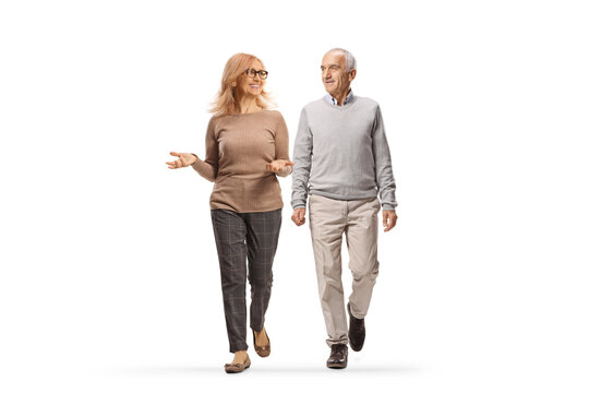 Mature man and woman walking together and talking - Powered by Adobe