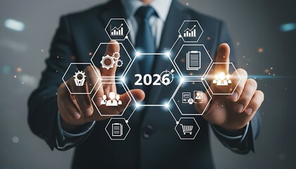 Businessman touching a futuristic interface displaying the year 2026 with various business icons and network connections