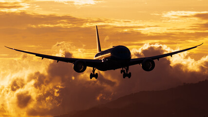 airplane landing at sunset
