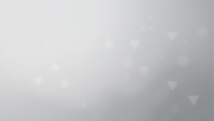 A blurry gray background with a few white circles. The background is mostly gray with some white