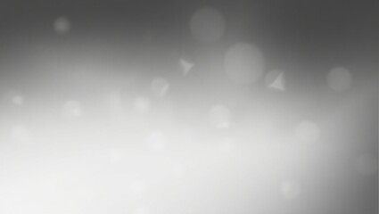 A blurry gray background with a few white circles. The background is mostly gray with some white