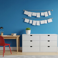 Bright blue wall interior with a modern white cabinet, a wooden desk, and photo frames hanging on the wall