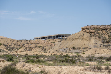 Desert landscape with abandoned structure under clear blue sky