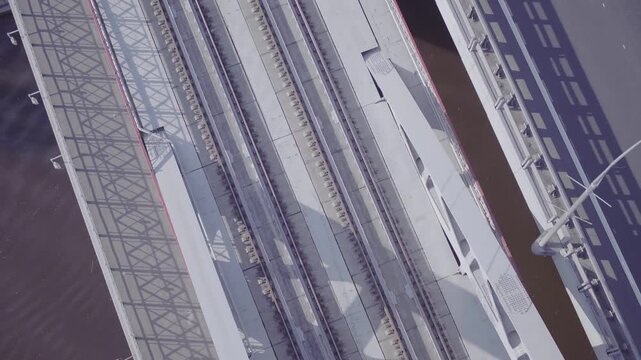Aerial view of metal railway bridge over city, D-Log footage