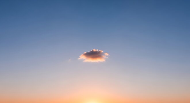 Gentle skies at twilight: Soft cloud illuminated by a setting sun creates a serene and beautiful atmosphere, perfect for contemplation.