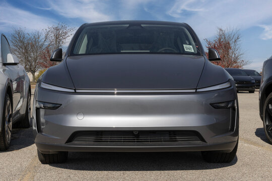 Tesla Model Y display at a dealership. Tesla offers the Model Y with up to 327 miles of driving range. MY:2026