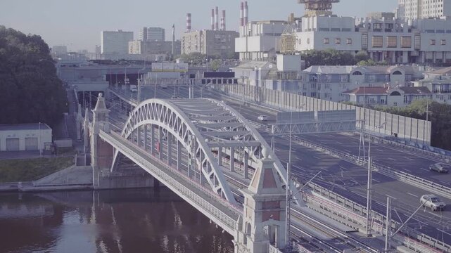 Drone view of city bridge with cars and trains, D-Log footage