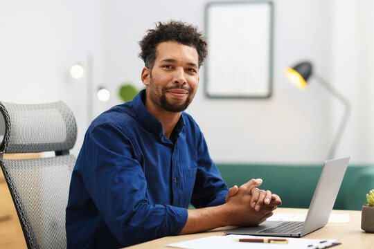 Portrait of man at table in office
