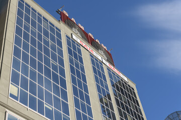 Fototapeta premium Sam the Record Man sign installed atop 277 Victoria St, facing Sankofa Square, Toronto