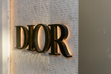 Fototapeta premium close-up of sign outside DIOR, a clothing store, located at 131 Bloor St W, Floor 1 of The Colonnade, Toronto