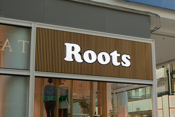 Fototapeta premium soft, defocused view of Roots sign on the outside of shop at CF Toronto Eaton Centre, Floor 3, 220 Yonge St Unit C, Toronto