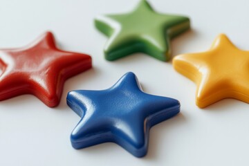 Obraz premium A collection of vibrant plastic star shapes in red, blue, yellow, and green.