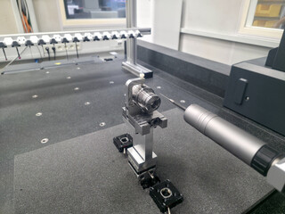 Cmm probe measures intricate fixture on inspection table with surgical accuracy, ensuring perfection