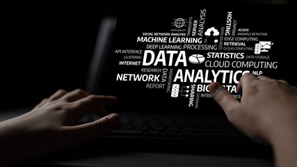 A close-up image of hands typing on a laptop, surrounded by abstract textual elements related to data analytics, cloud computing, and machine learning in a dark and moody setting. Tessel