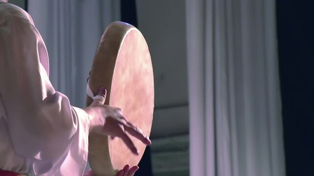 Central Asian National Drum. Man in national dress holding Asian drum. Slow Motion