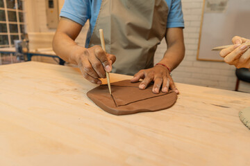Latin American man creating pottery in workshop