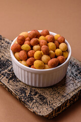 Food, nuts coated with salt and paprika, peanuts as a source of protein. Salted peanuts