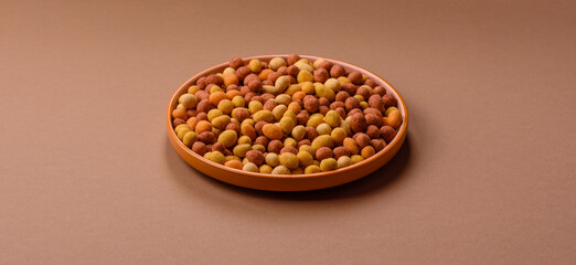 Food, nuts coated with salt and paprika, peanuts as a source of protein. Salted peanuts