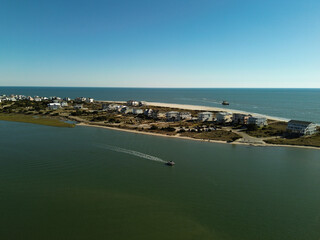 Aerial view of homes along the intracoastal waterway and ocean on the Western end of Oak Island North Carolina
